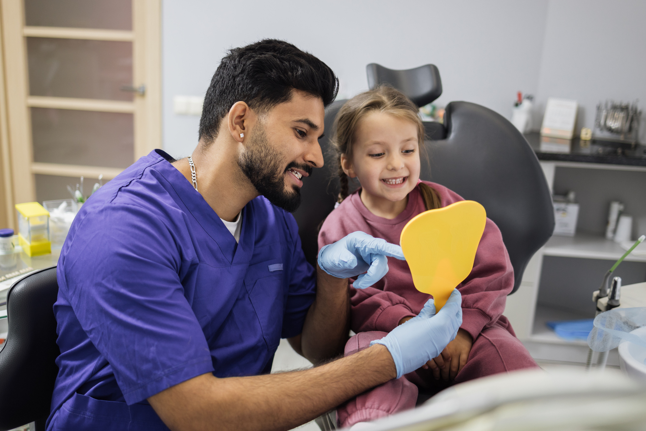 dentist and young patient smiling