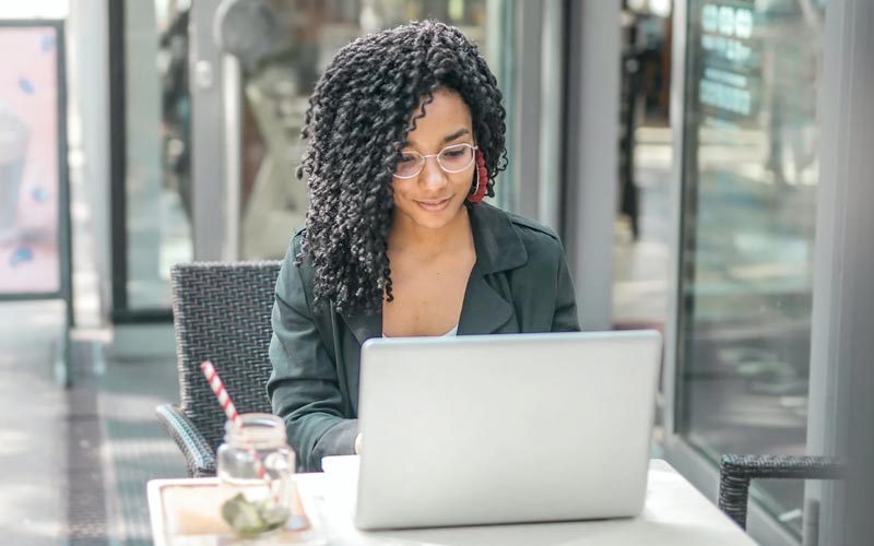 A woman studies on a laptop