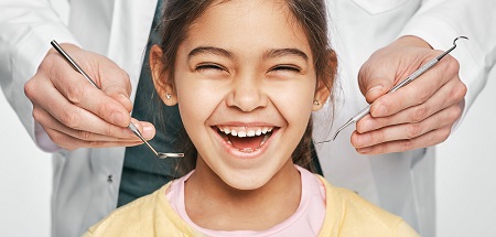 A grid of many young children smiling and happy